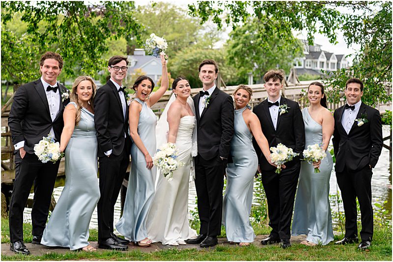 Samantha and Garrett with their wedding party in pale blue dresses and black tuxedos in Spring Lake, New Jersey